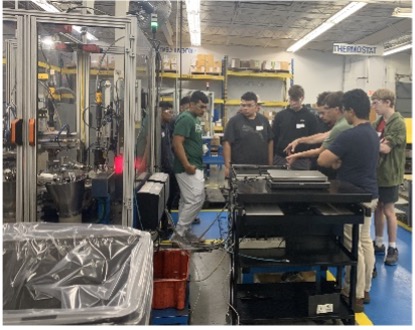 Students Observe Automated Assembly Cell Manufacturing Same Parts.