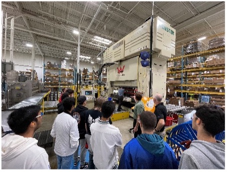 Students Shown Parts Being Manufactured in Stamping Press.