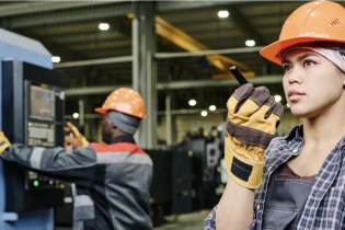 Two workers on a manufacturing shop floor.