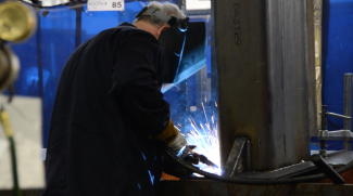 A manufacturer welding a workpiece.