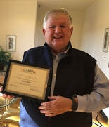 Steve Griffin holding a plaque. 